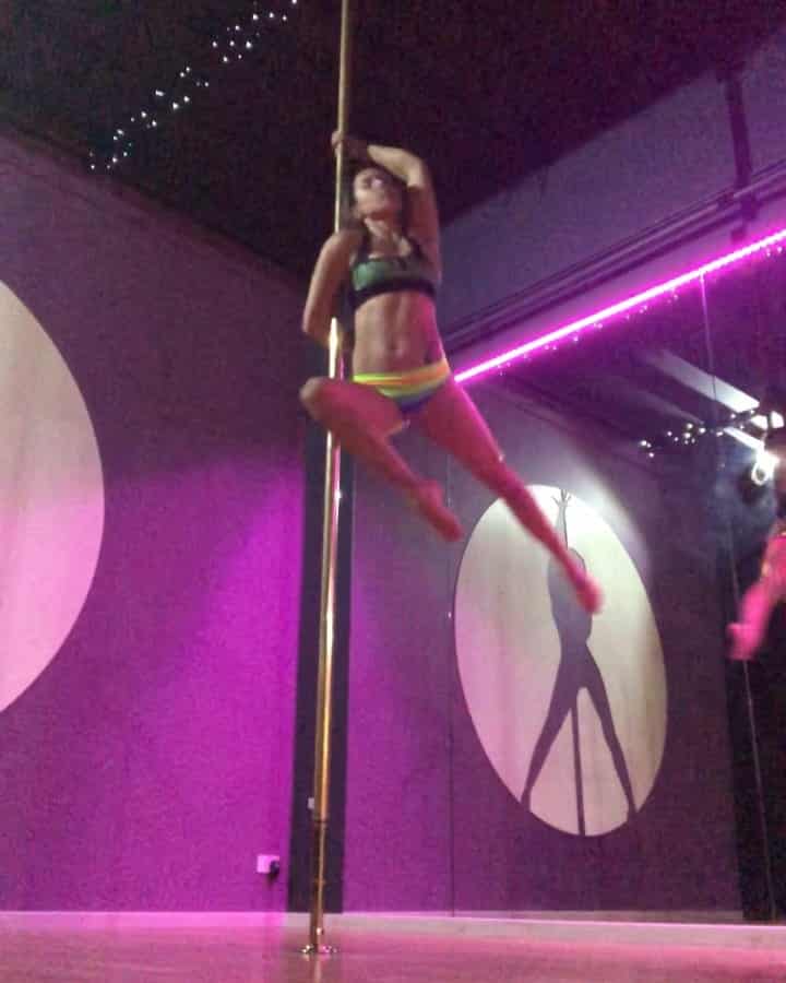 image of woman performing on stage, pole dancing classes, pole fitness, group fitness classes