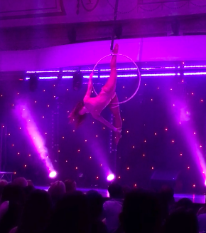 video image of woman performing hoop routine at Miss Lyra Australia 2017 under purple lights, aerial silks, aerial fitness