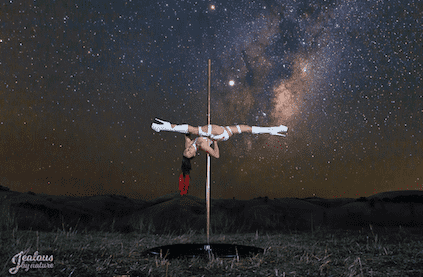 woman performing jade spit in field in front of stars with galaxy theme photoshoot taken by Jealous By Nature
