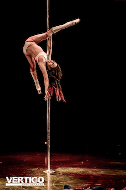 woman performing drag themed routine on stage doing flexy back trick