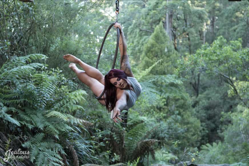 Woman in lyra hoop in nature photoshoot arched back hanging, aerial classes, aerial silk classes, aerial silks, aerial fitness