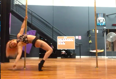 video image of woman dancing lyrical routine on two poles in studio