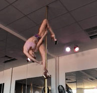 video image of woman training spins and tricks on the pole in studio